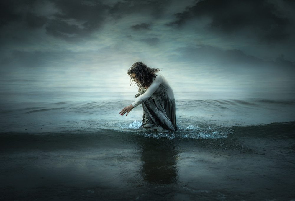 Lost Forever by Jessica Drossin - Woman losing something in the sea, watching it fall under the waves.